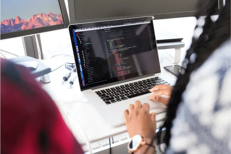 Person coding in Java on laptop, illustrating Spring Boot and Microservices training.