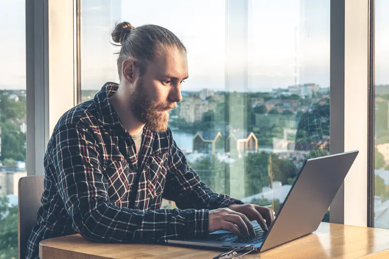 Man coding on laptop, illustrating Java training and software development skills.