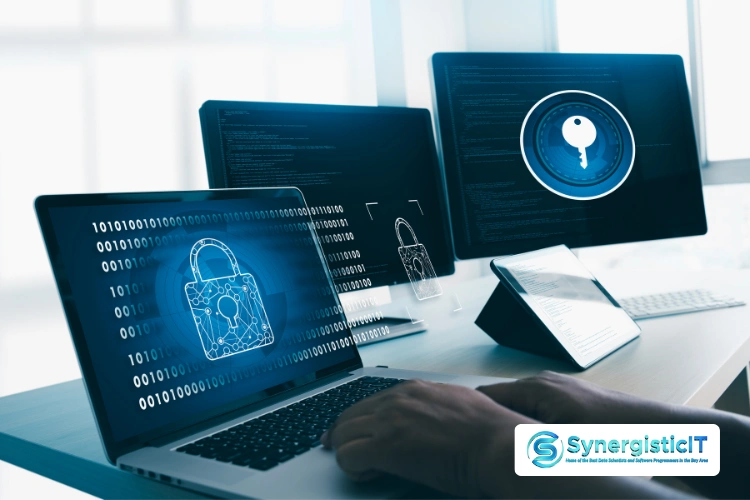 Cybersecurity interview preparation with laptops displaying code and a lock icon, representing data protection.