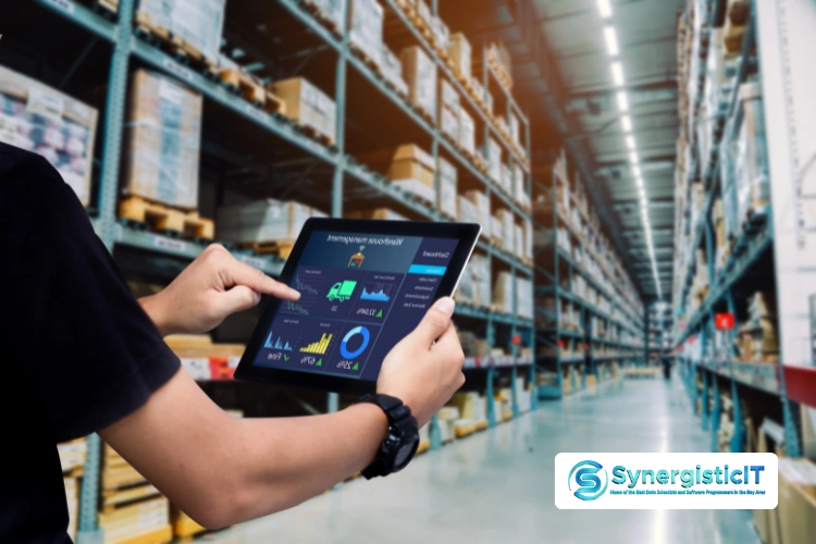 Informatica ETL tool dashboard displayed on tablet in warehouse environment.