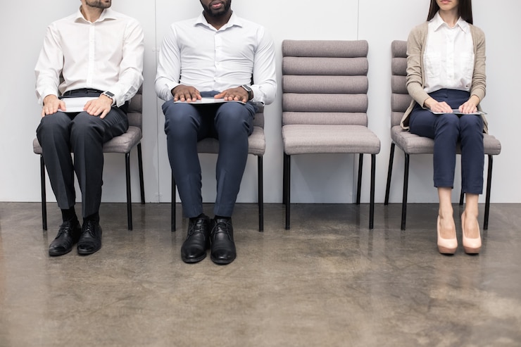 Job candidates waiting for interviews, preparing for interview strategies and techniques.