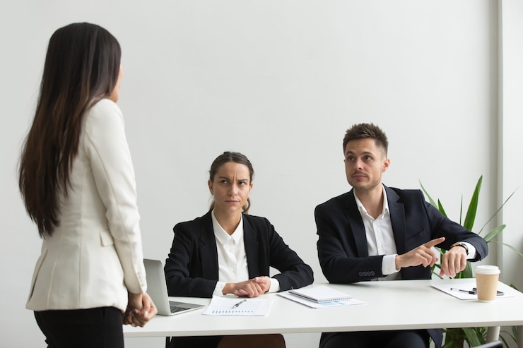 Job interview scenario with interviewer and candidate discussing professional attire and body language.