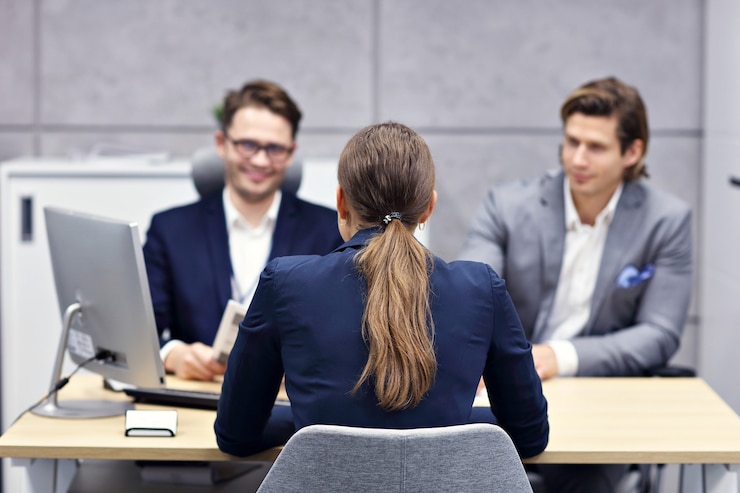 Panel interview setting with multiple interviewers and a candidate.