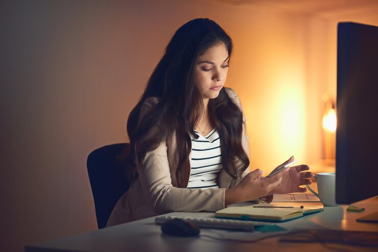 Woman preparing for job interview, reviewing answers and practicing with notebook and computer.