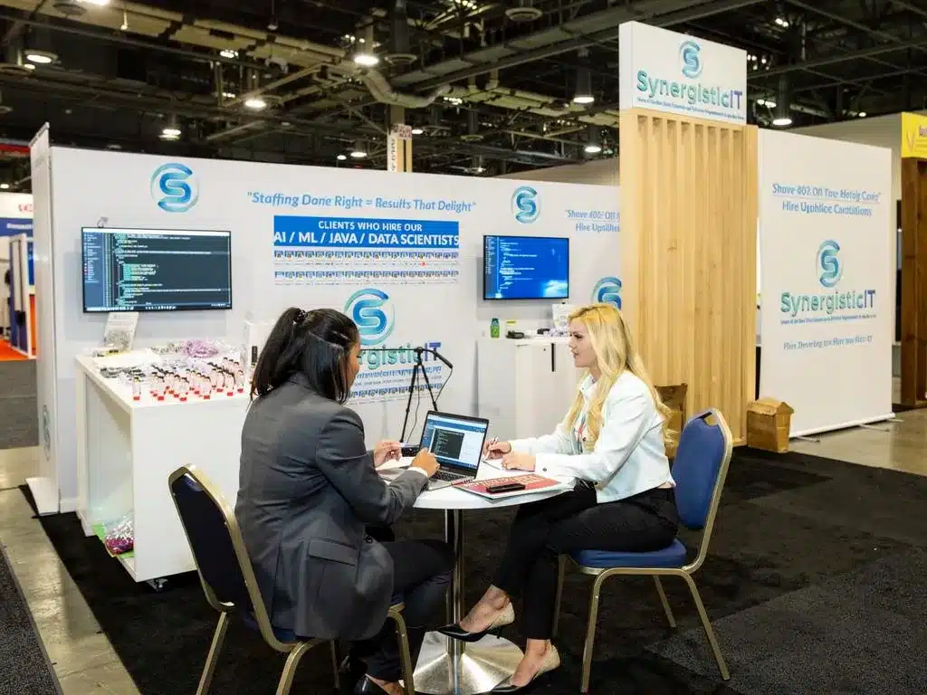SynergisticIT booth at career fair, staffing and IT skill enhancement solutions, AI/Java/data scientists.