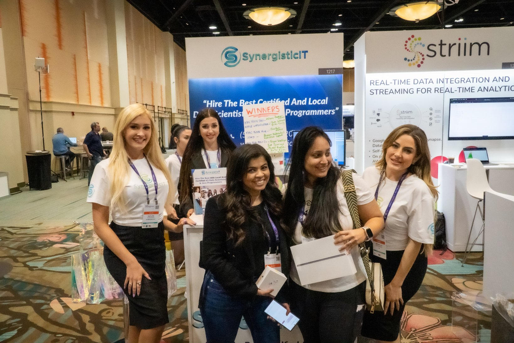Group of women at a conference promoting tech services and networking